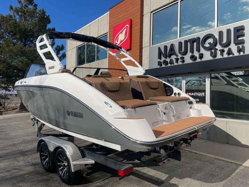Slide: The Image of 2025 Yamaha Boats 222SD on trailer outside Nautique dealership. - 3