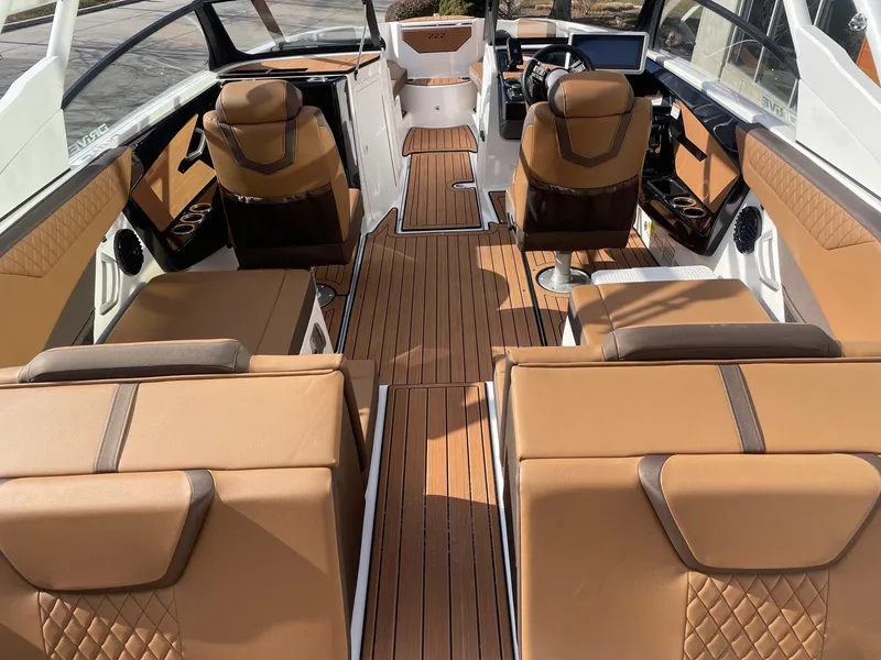 Slide: The Image of Luxurious interior of 2025 Yamaha Boats 222SD with brown leather seating and wood flooring. - 4