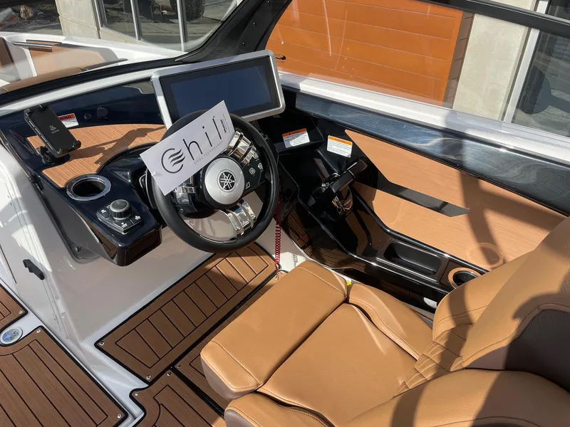 Slide: The Image of 2025 Yamaha Boats 222SD cockpit with modern controls and tan seating. - 6
