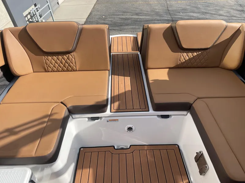 Slide: The Image of 2025 Yamaha Boats 222SD interior with tan seating and wood accents. - 8
