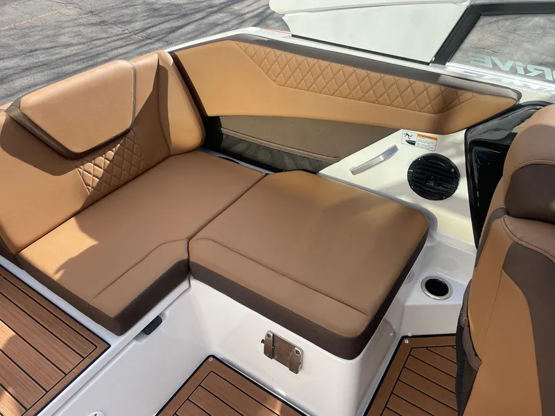 Slide: The Image of 2025 Yamaha Boats 222SD interior with tan seating and wood accents. - 9
