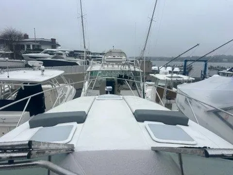 Slide: The Image of 2004 Formula 34 PC yacht docked among other boats on a cloudy day. - 13