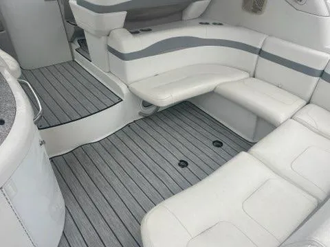 Slide: The Image of 2004 Formula 34 PC boat interior with white seating and striped flooring. - 14