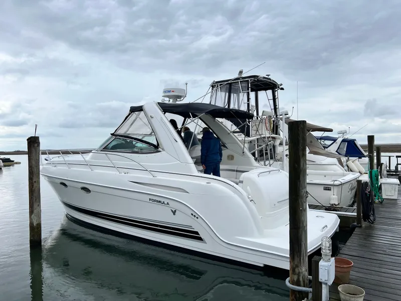 Slide: The Image of 2004 Formula 34 PC yacht docked at marina under cloudy sky. - 2