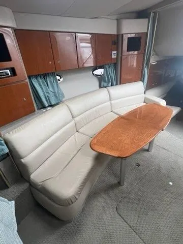 Slide: The Image of 2004 Formula 34 PC yacht interior with beige sofa and wooden table. - 20