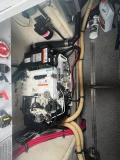 Slide: The Image of Engine compartment of a 2004 Formula 34 PC boat, showing mechanical components and wiring. - 26