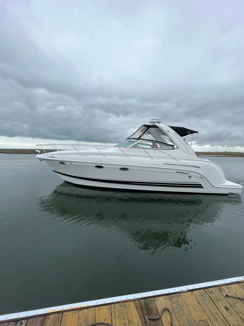 Slide: The Image of 2004 Formula 34 PC yacht on calm water under cloudy skies. - 4