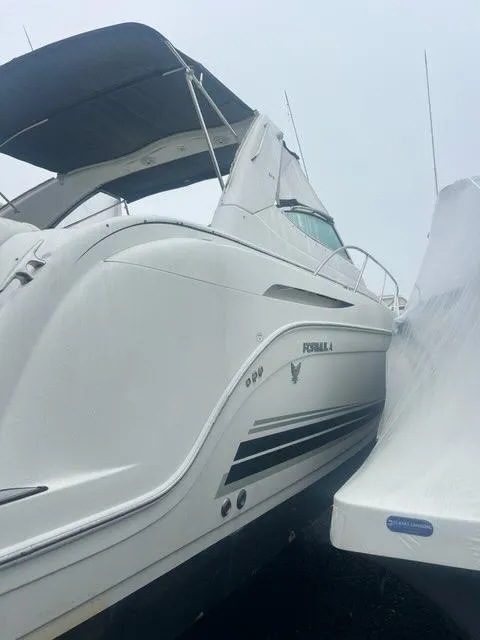 Slide: The Image of 2004 Formula 34 PC boat with sleek design and white exterior. - 7