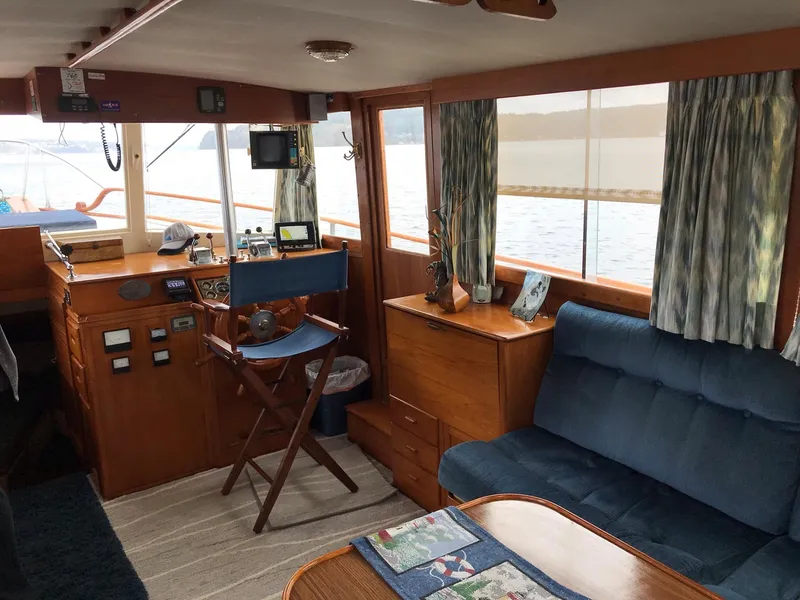 Slide: The Image of Interior of a 1969 Grand Banks 42 Classic yacht with wooden furnishings and blue seating. - 14