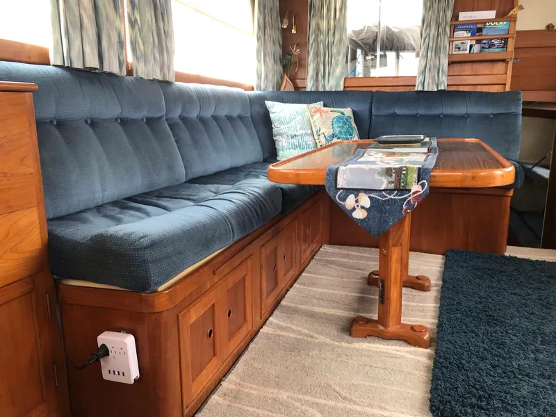 Slide: The Image of Interior of a 1969 Grand Banks 42 Classic yacht with blue seating and wooden table. - 17