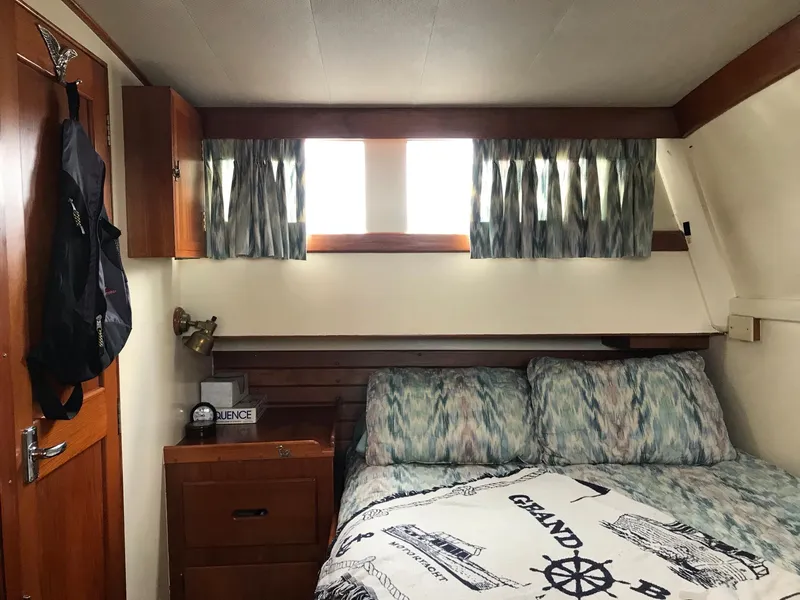 Slide: The Image of Cozy cabin interior of 1969 Grand Banks 42 Classic with bed and wooden furnishings. - 2