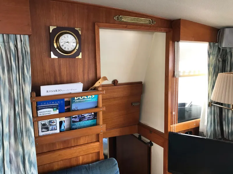Slide: The Image of Interior of 1969 Grand Banks 42 Classic with wooden paneling, clock, and bookshelf. - 21
