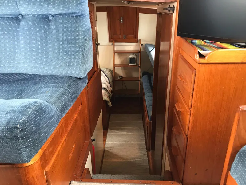 Slide: The Image of Interior of 1969 Grand Banks 42 Classic yacht with wooden cabinetry and blue upholstery. - 22