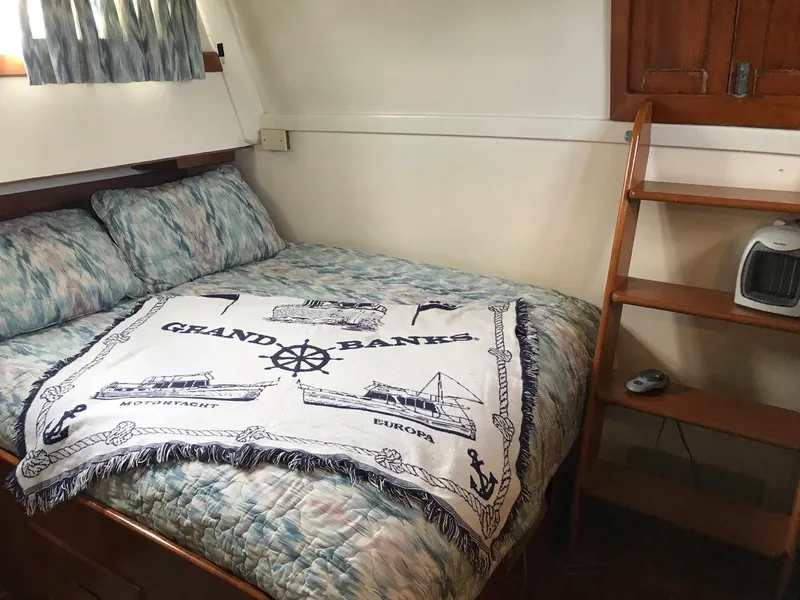 Slide: The Image of Cozy cabin interior of 1969 Grand Banks 42 Classic with nautical-themed bedding. - 23