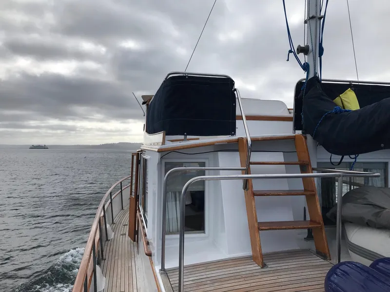 Slide: The Image of 1969 Grand Banks 42 Classic yacht on open water under cloudy skies. - 27