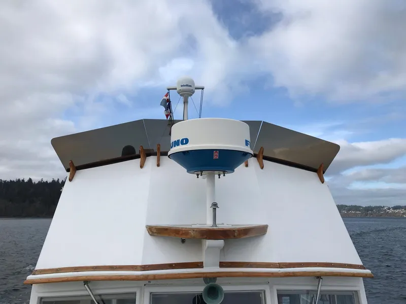 Slide: The Image of Grand Banks 42 Classic 1969 boat with radar, cruising under cloudy skies. - 29