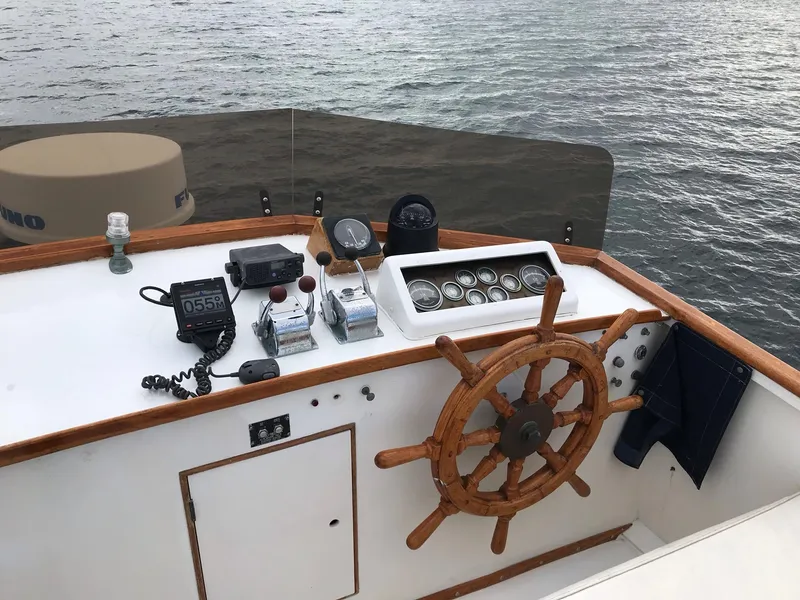 Slide: The Image of Helm of 1969 Grand Banks 42 Classic boat with wooden wheel and navigation instruments. - 32
