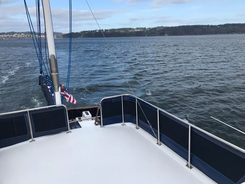 Slide: The Image of 1969 Grand Banks 42 Classic yacht on open water, featuring a spacious deck and scenic view. - 33