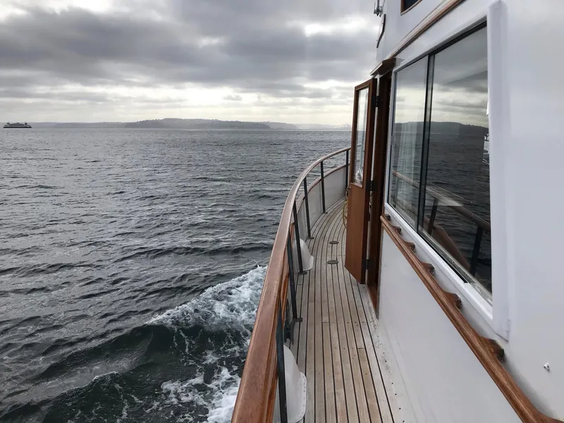 Slide: The Image of Side view of 1969 Grand Banks 42 Classic yacht cruising on open water. - 4