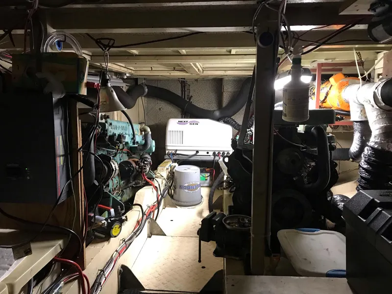 Slide: The Image of Engine room of a 1969 Grand Banks 42 Classic boat, showcasing mechanical components and wiring. - 42