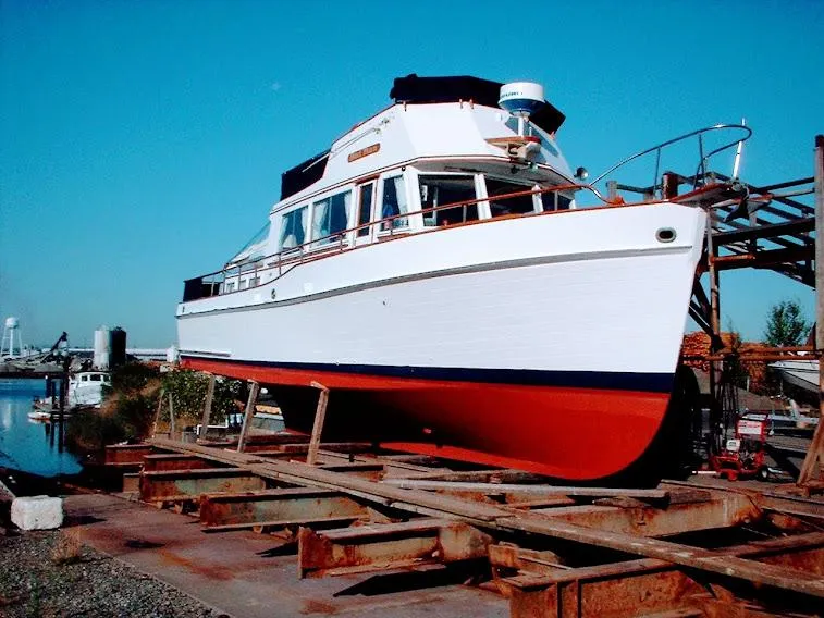 Slide: The Image of 1969 Grand Banks 42 Classic yacht on dry dock with blue sky background. - 47