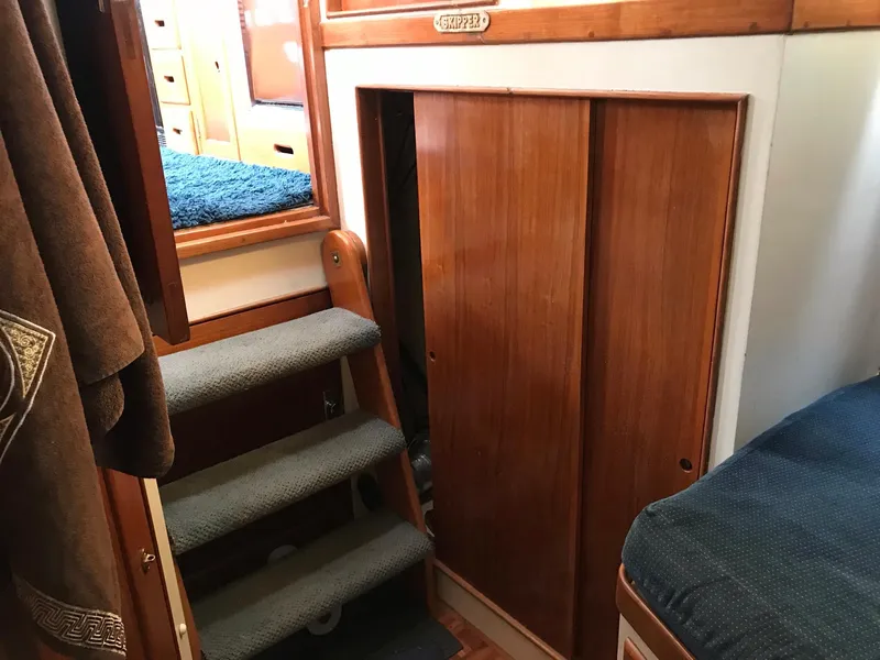 Slide: The Image of Interior of 1969 Grand Banks 42 Classic with wooden paneling and carpeted stairs. - 6