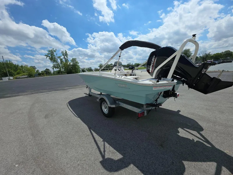 Slide: The Image of 2025 Boston Whaler 160 Super Sport boat on trailer under blue sky. - 3