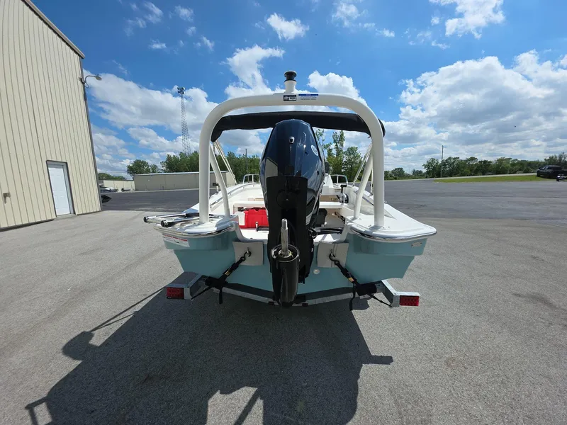 Slide: The Image of 2025 Boston Whaler 160 Super Sport boat on trailer, rear view under blue sky. - 4