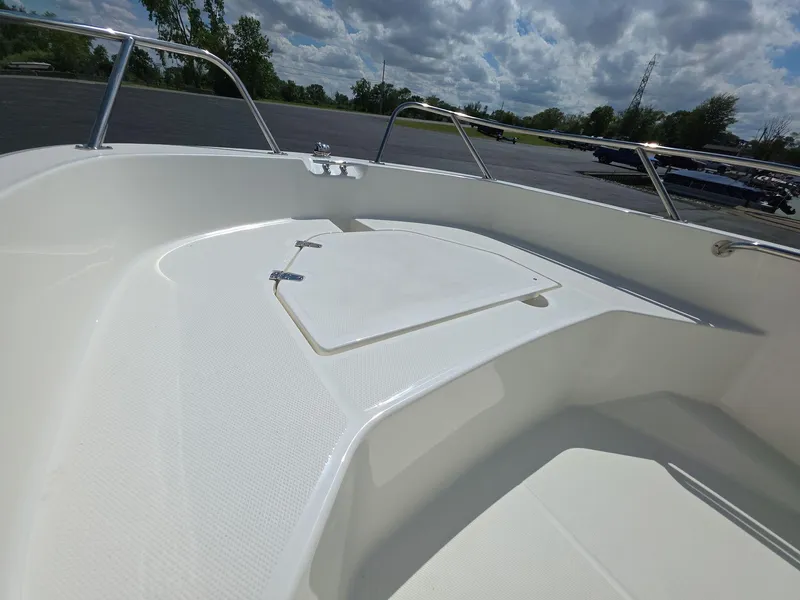 Slide: The Image of 2025 Boston Whaler 160 Super Sport boat deck under a cloudy sky. - 5