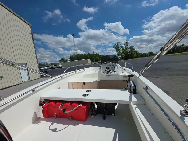 Slide: The Image of 2025 Boston Whaler 160 Super Sport boat interior under a clear blue sky. - 7