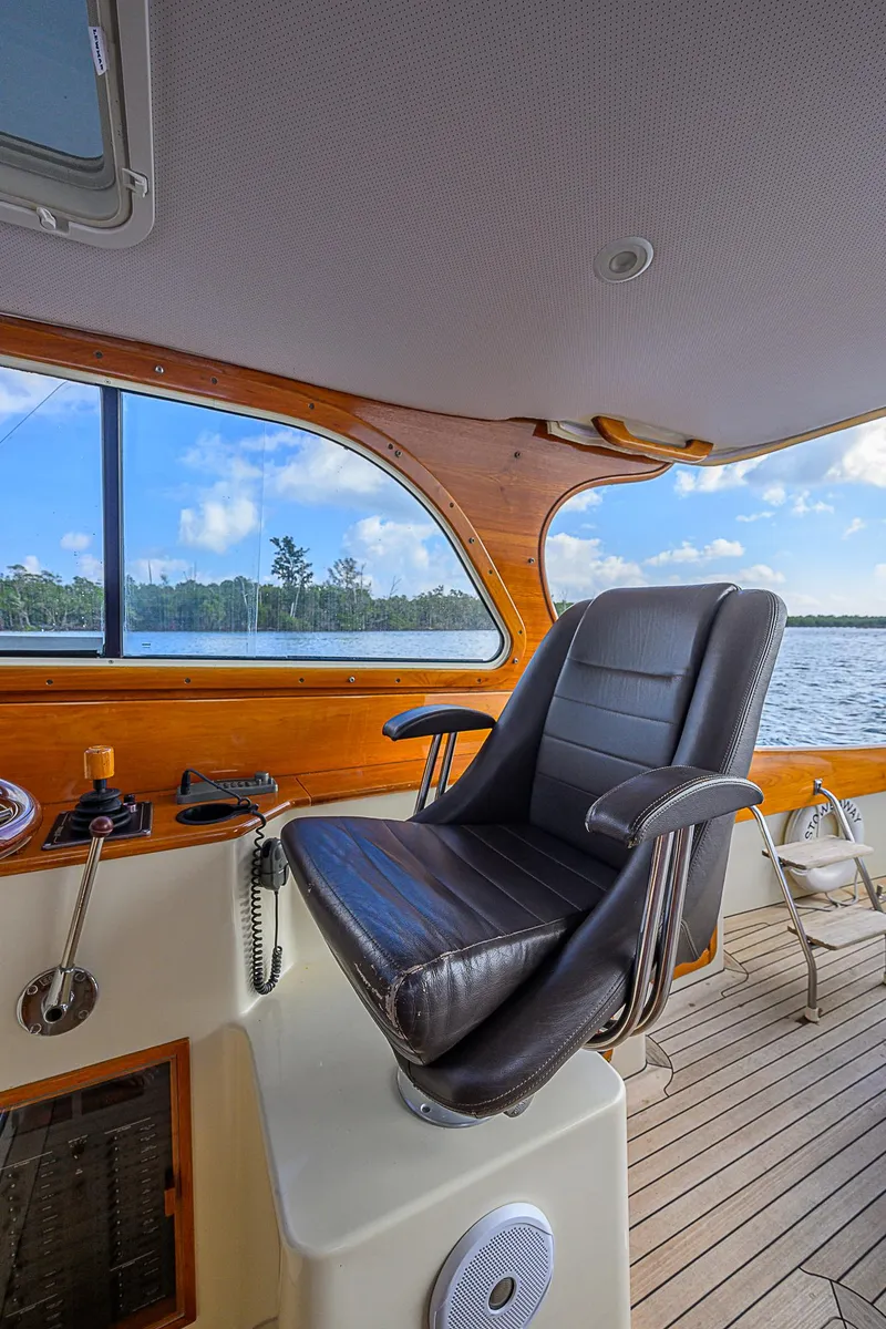Slide: The Image of Captain's chair on 2000 Hinckley Picnic Boat Classic, overlooking serene waters. - 11