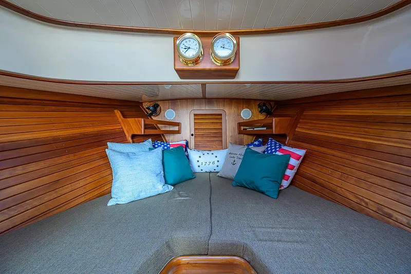 Slide: The Image of Interior of 2000 Hinckley Picnic Boat Classic with cozy cushions and wooden paneling. - 19