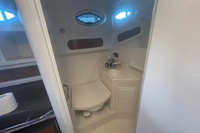 Slide: The Image of 2003 Monterey 302 Cruiser bathroom interior with sink and toilet. - 11