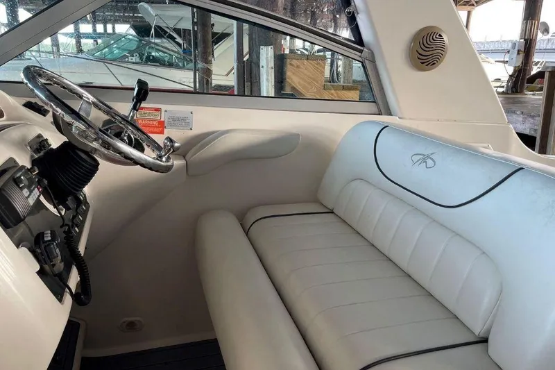 Slide: The Image of Interior of 2003 Monterey 302 Cruiser with white seating and steering wheel. - 12