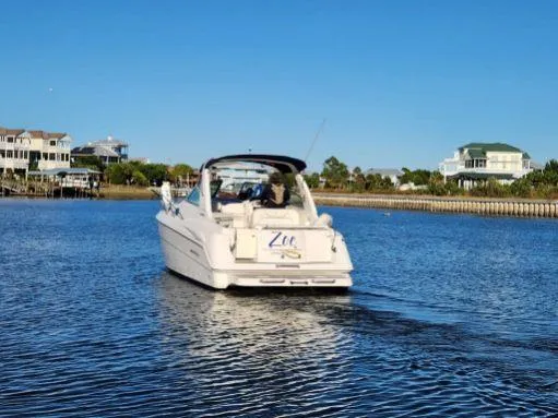 Slide: The Image of 2003 Monterey 302 Cruiser on calm water near waterfront homes. - 5