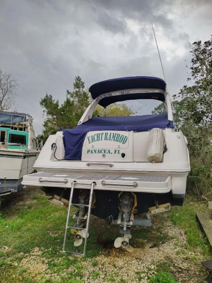 Slide: The Image of 2003 Monterey 302 Cruiser yacht on land with overcast sky. - 6