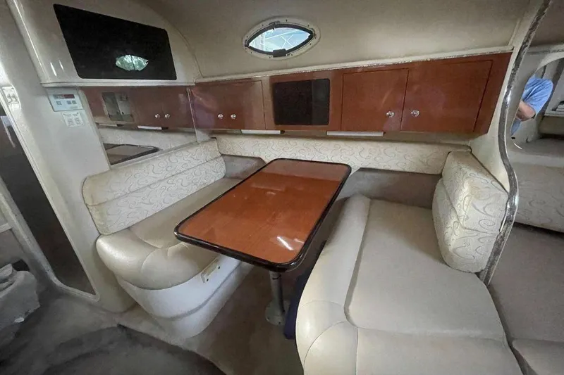 Slide: The Image of Interior of a 2003 Monterey 302 Cruiser with dining area and wooden table. - 8