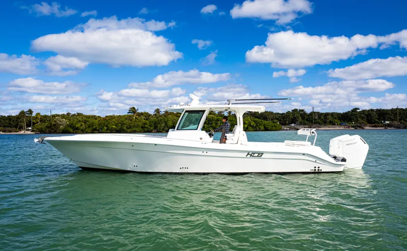Slide: The Image of 2023 HCB 39 Speciale boat on calm water under a blue sky. - 3