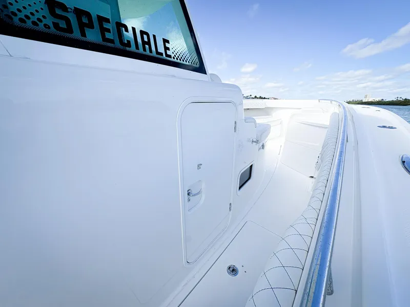 Slide: The Image of 2023 HCB 39 Speciale boat, sleek white design, spacious deck, clear blue sky. - 31
