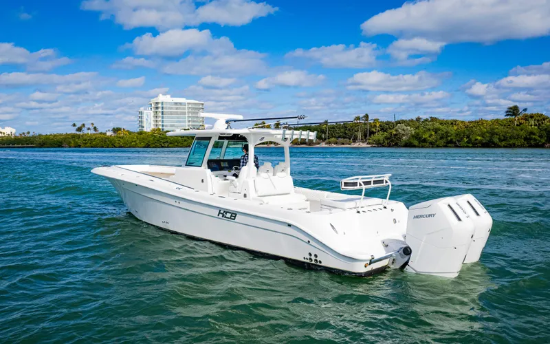Slide: The Image of 2023 HCB 39 Speciale boat cruising on clear blue water under a sunny sky. - 39