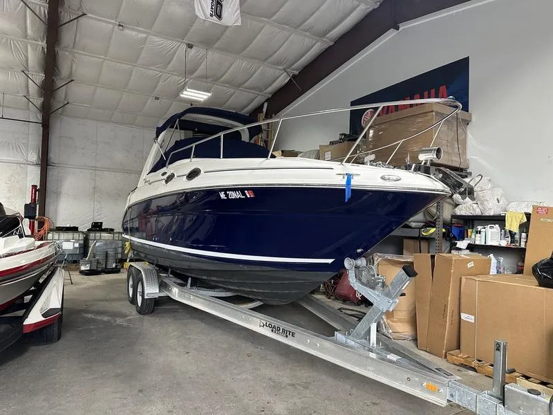 The Image of 2004 Sea Ray 260 Sundancer boat on trailer in storage facility. - 0