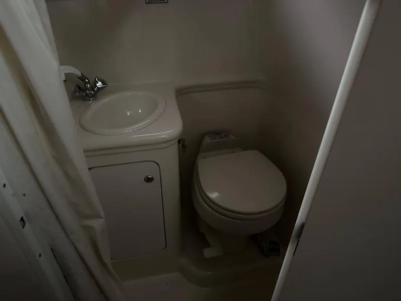 Slide: The Image of Interior of 2004 Sea Ray 260 Sundancer with beige seating and wood accents. - 14