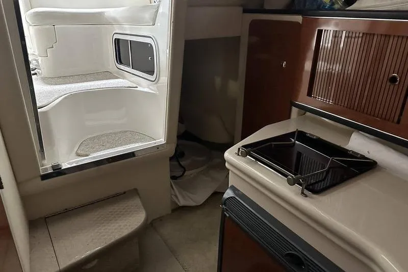 Slide: The Image of Interior of 2004 Sea Ray 260 Sundancer boat with kitchenette and cabin entry. - 20