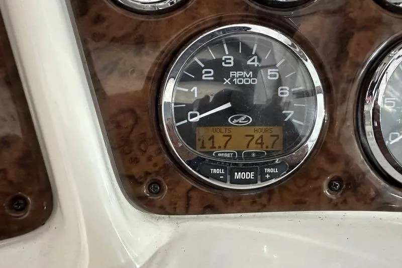 Slide: The Image of Close-up of 2004 Sea Ray 260 Sundancer RPM gauge displaying volts and hours. - 22