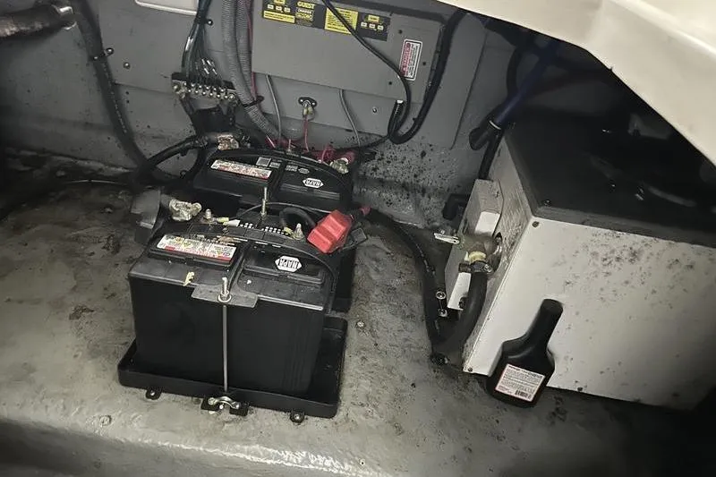 Slide: The Image of Engine compartment of a 2004 Sea Ray 260 Sundancer with batteries and wiring. - 23