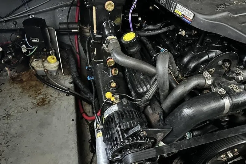 Slide: The Image of Engine compartment of a 2004 Sea Ray 260 Sundancer boat, showing detailed components. - 25