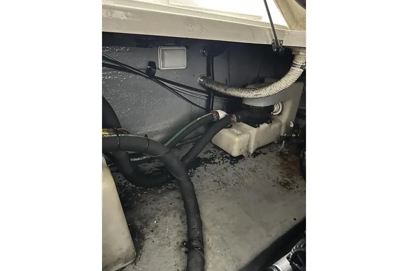 Slide: The Image of Engine compartment of a 2004 Sea Ray 260 Sundancer boat, showing hoses and components. - 26