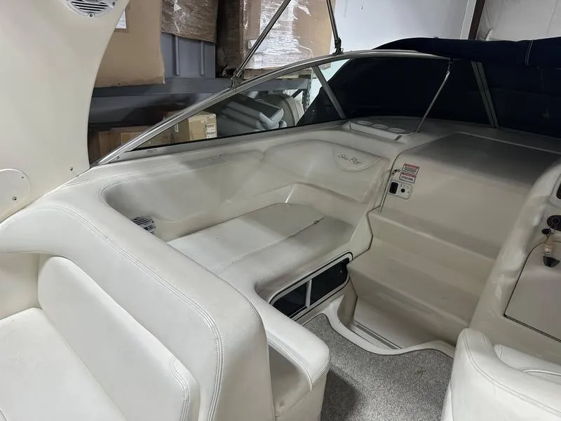 Slide: The Image of 2004 Sea Ray 260 Sundancer interior seating with white upholstery and coiled rope. - 7