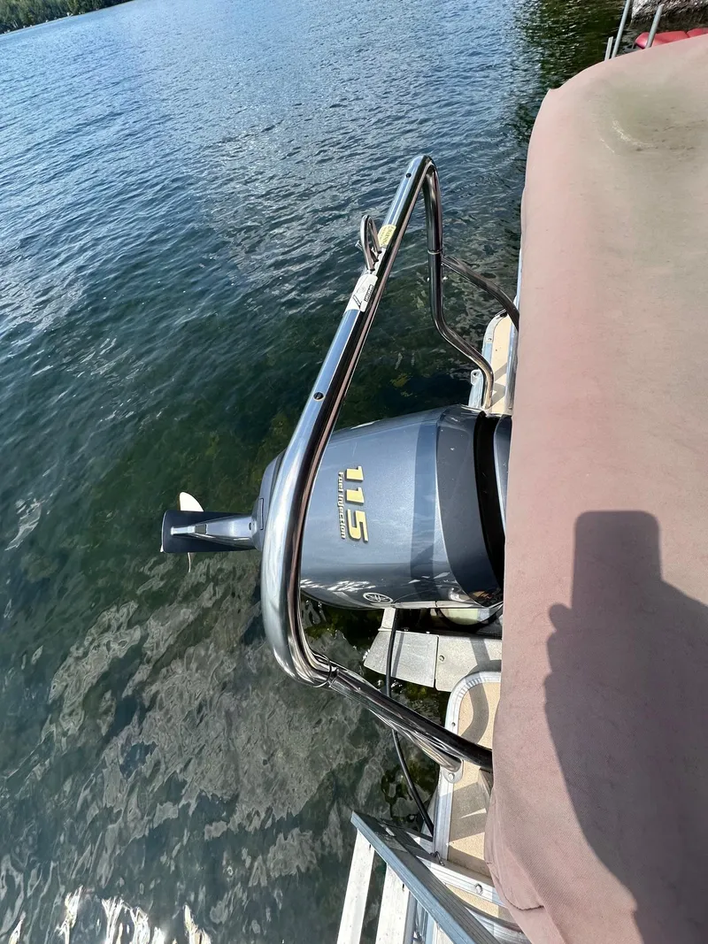 Slide: The Image of Boat with Godfrey 2086 motor, 2012 model, on a calm lake. - 2