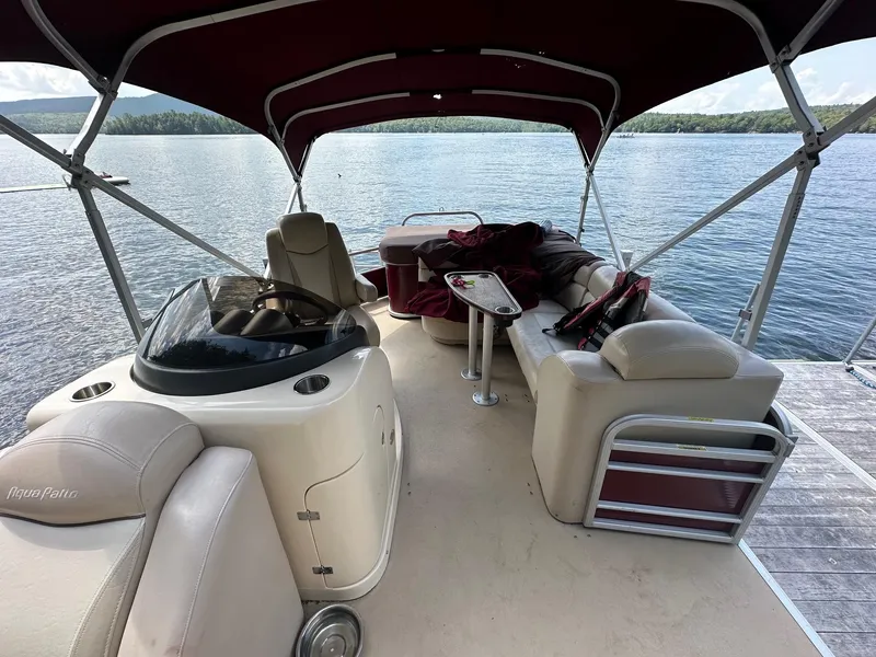 Slide: The Image of 2012 Godfrey 2086 pontoon boat with canopy on a serene lake. - 3